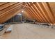 Unfinished attic space with exposed wooden beams, offering potential for storage or renovation at 302 Rushingwater Dr, Cary, NC 27513