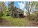 Exterior view of the backyard featuring a wooden deck and lush green grass at 302 Rushingwater Dr, Cary, NC 27513