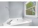 Close up view of a soaking tub with bright window at 302 Rushingwater Dr, Cary, NC 27513