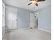Carpeted bedroom with neutral walls featuring ceiling fan and views of the house interior at 302 Rushingwater Dr, Cary, NC 27513