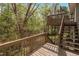 Wooden deck with stairs to backyard, perfect for enjoying nature and outdoor living at 302 Rushingwater Dr, Cary, NC 27513