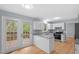 Modern kitchen features granite countertops, stainless steel appliances, and backyard access at 302 Rushingwater Dr, Cary, NC 27513
