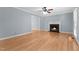 Bright living room with hardwood floors, fireplace and ceiling fan at 302 Rushingwater Dr, Cary, NC 27513