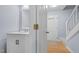 Convenient powder room with a white vanity and a marble countertop on the main level at 302 Rushingwater Dr, Cary, NC 27513
