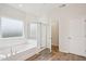 Bright bathroom features a luxurious tub, a separate glass-enclosed shower, and stylish tile flooring at 3348 Table Mountain Pine Dr, Raleigh, NC 27616
