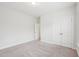 Empty bedroom featuring neutral carpet, double doors, and ample natural light at 3348 Table Mountain Pine Dr, Raleigh, NC 27616