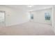 An inviting bedroom featuring neutral carpet, recessed lighting, and natural light from large windows at 3348 Table Mountain Pine Dr, Raleigh, NC 27616