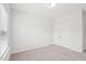 A bright bedroom offers neutral carpeting, crisp white walls, and a closet at 3348 Table Mountain Pine Dr, Raleigh, NC 27616