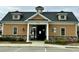 Attractive clubhouse featuring a stone facade, well-manicured landscaping, and private pool access at 3348 Table Mountain Pine Dr, Raleigh, NC 27616