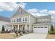 Charming two-story home with green siding, a covered front porch, and a two-car garage at 3348 Table Mountain Pine Dr, Raleigh, NC 27616