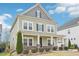 Charming two-story home showcasing a welcoming porch, manicured landscaping, and a two car garage at 3348 Table Mountain Pine Dr, Raleigh, NC 27616