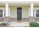 Inviting front door with decorative brick accents and a charming welcome mat at 3348 Table Mountain Pine Dr, Raleigh, NC 27616