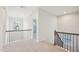 Second story hall and stairs with light neutral carpet and wood banisters at 3348 Table Mountain Pine Dr, Raleigh, NC 27616