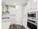 Modern kitchen with white cabinets, stainless steel appliances, and tile backsplash at 3348 Table Mountain Pine Dr, Raleigh, NC 27616