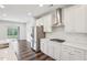 Well-lit kitchen featuring stainless steel appliances, quartz countertops, and dark wood flooring at 3348 Table Mountain Pine Dr, Raleigh, NC 27616