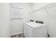 Bright laundry room offers wood-look flooring, a window, washer, and dryer at 3348 Table Mountain Pine Dr, Raleigh, NC 27616