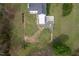Aerial view of the home showing a fully fenced backyard with the home and covered back porch at 3690 Mabel Ln, Stem, NC 27581