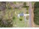 Overhead shot displays the home's layout on a large lot surrounded by mature trees at 3690 Mabel Ln, Stem, NC 27581