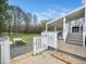 Picturesque back deck offers outdoor seating and scenic views of the expansive yard at 3690 Mabel Ln, Stem, NC 27581