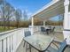 Large deck features outdoor seating with a nice view of the backyard at 3690 Mabel Ln, Stem, NC 27581