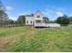 Expansive backyard features a large deck, ample green space, and a sturdy fence at 3690 Mabel Ln, Stem, NC 27581