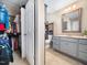Hallway view of a bathroom featuring a large vanity and combination shower and tub at 3690 Mabel Ln, Stem, NC 27581