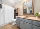 Bathroom with a combination shower and tub, a large vanity, and open shelving at 3690 Mabel Ln, Stem, NC 27581