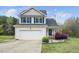 Charming two-story home featuring a well-manicured lawn, attached garage, and inviting front porch at 3690 Mabel Ln, Stem, NC 27581