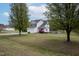 Charming two-story home is nestled amongst mature trees in a well maintained yard at 3690 Mabel Ln, Stem, NC 27581
