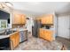 Traditional kitchen featuring light wood cabinets, stainless steel appliances and a tiled floor at 3690 Mabel Ln, Stem, NC 27581