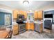 Well-equipped kitchen featuring stainless steel appliances, light wood cabinets, and ample counter space at 3690 Mabel Ln, Stem, NC 27581