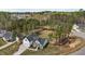 Aerial view showcases the home, garage and surrounding landscape with mature trees and generous lawn space at 381 Heart Pine Dr, Wendell, NC 27591