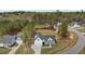 Aerial view of a beautiful white home with a spacious lawn, surrounded by lush greenery at 381 Heart Pine Dr, Wendell, NC 27591