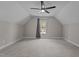 Spacious attic featuring neutral colored walls and carpeting and a ceiling fan at 381 Heart Pine Dr, Wendell, NC 27591