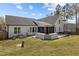 Expansive backyard featuring a wooden deck, covered porch, and ample space for outdoor activities at 381 Heart Pine Dr, Wendell, NC 27591