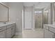 Bathroom with double sinks, cabinet storage, a walk-in shower and tile flooring at 381 Heart Pine Dr, Wendell, NC 27591