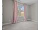 Cozy bedroom featuring a window with light pink drapes and neutral carpeting at 381 Heart Pine Dr, Wendell, NC 27591
