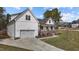 Charming two-story home with a white exterior, two-car garage and landscaped front yard at 381 Heart Pine Dr, Wendell, NC 27591