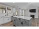 Kitchen features white cabinets, stainless steel appliances, and a central island, blending style and functionality at 381 Heart Pine Dr, Wendell, NC 27591