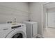 Well-lit laundry room features a Whirlpool washer and dryer and wire shelving at 381 Heart Pine Dr, Wendell, NC 27591