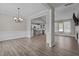 Open-concept living spaces with hardwood floors, flowing into a bright kitchen with white cabinets at 381 Heart Pine Dr, Wendell, NC 27591