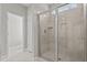Modern walk-in shower with tiled walls, glass door, and a window for natural light at 381 Heart Pine Dr, Wendell, NC 27591