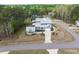An aerial view reveals a landscaped modern home with an accessory structure surrounded by green space and trees at 3908 Sage Ct, Wake Forest, NC 27587