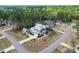 An aerial view showcases a modern home with an accessory structure surrounded by lush, mature trees at 3908 Sage Ct, Wake Forest, NC 27587