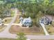 This aerial view highlights a modern home and guest house with lush landscaping in a peaceful, wooded setting at 3908 Sage Ct, Wake Forest, NC 27587