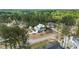 An aerial view captures a modern home and accessory structure nestled within a picturesque wooded landscape at 3908 Sage Ct, Wake Forest, NC 27587