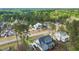 An aerial shot displays a modern home with an accessory structure and well-kept landscaping in a wooded area at 3908 Sage Ct, Wake Forest, NC 27587