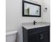 Bathroom features a square mirror, dark cabinet, and chrome hardware at 3908 Sage Ct, Wake Forest, NC 27587