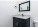 Bathroom vanity features a square mirror, dark cabinet, and chrome hardware at 3908 Sage Ct, Wake Forest, NC 27587