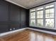 Stylish bedroom featuring dark walls, white trim, hardwood floors and natural light at 3908 Sage Ct, Wake Forest, NC 27587